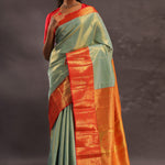 Pistachio Green Kanjivaram Tissue Silk Saree With Vibrant Orange Border