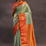 Pistachio Green Kanjivaram Tissue Silk Saree With Vibrant Orange Border
