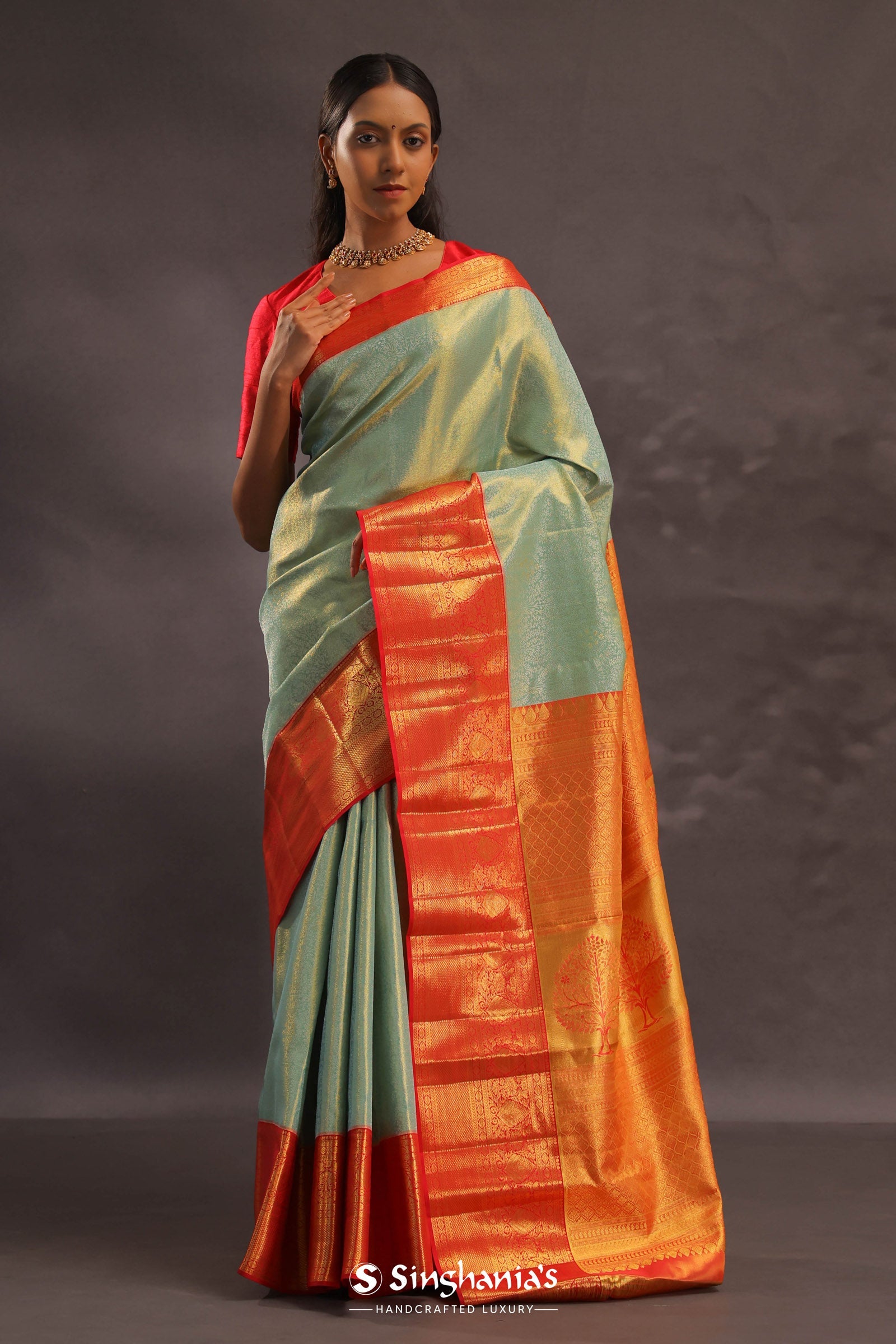 Pistachio Green Kanjivaram Tissue Silk Saree With Vibrant Orange Border