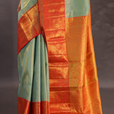 Pistachio Green Kanjivaram Tissue Silk Saree With Vibrant Orange Border
