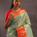 Pistachio Green Kanjivaram Tissue Silk Saree With Vibrant Orange Border