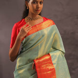 Pistachio Green Kanjivaram Tissue Silk Saree With Vibrant Orange Border