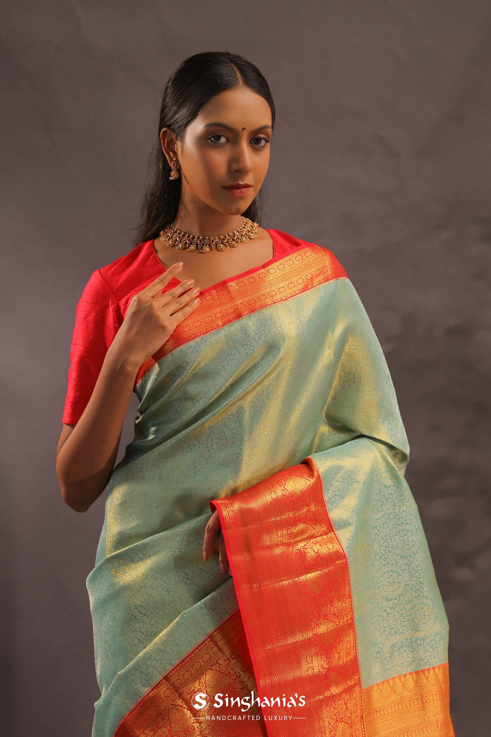 Pistachio Green Kanjivaram Tissue Silk Saree With Vibrant Orange Border