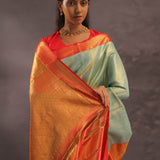 Pistachio Green Kanjivaram Tissue Silk Saree With Vibrant Orange Border