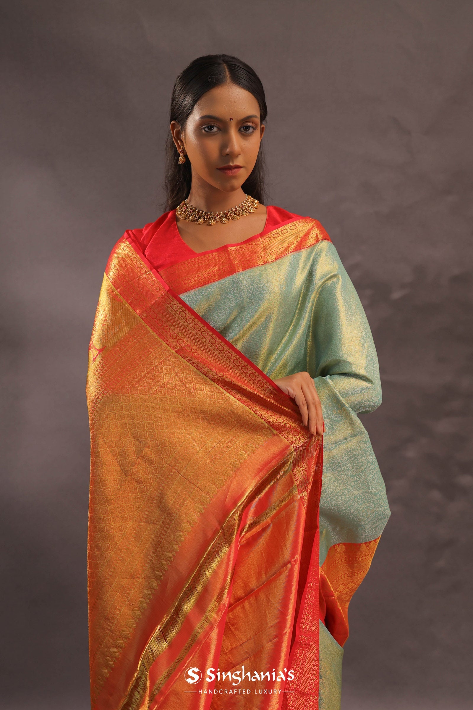 Pistachio Green Kanjivaram Tissue Silk Saree With Vibrant Orange Border