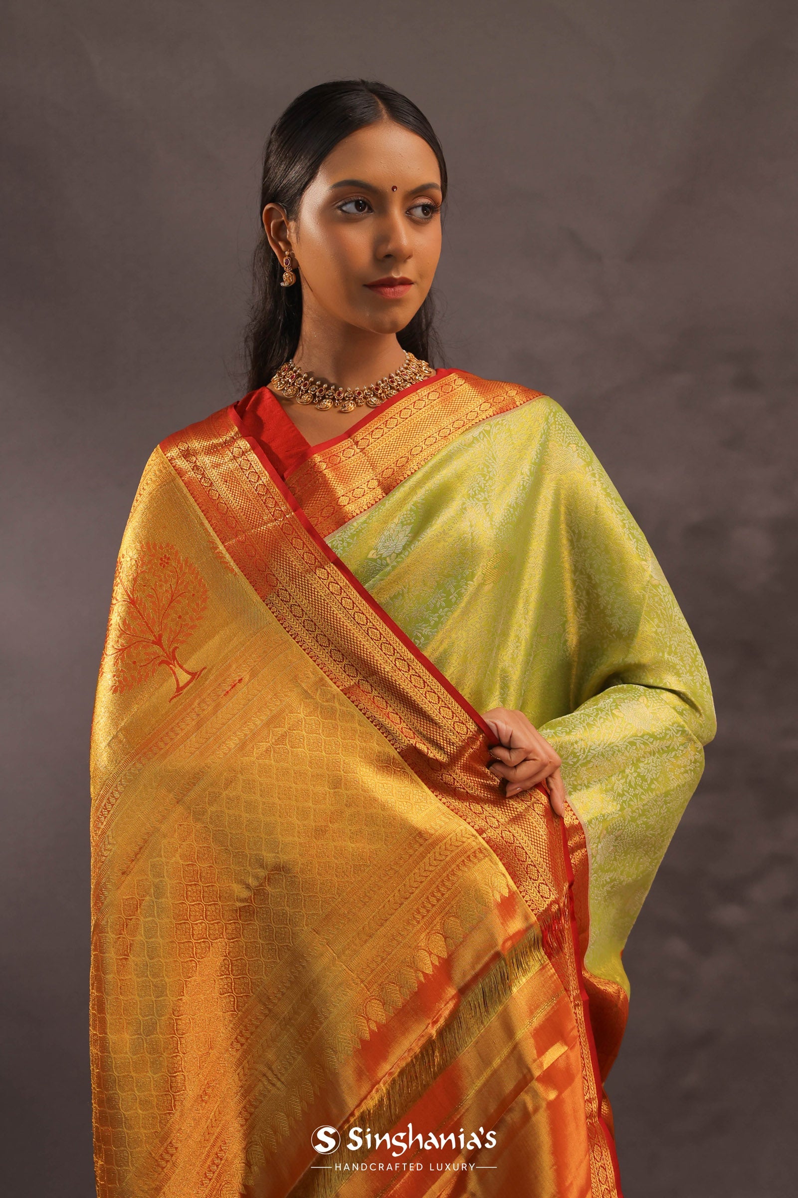 Soft Lime Green Kanjivaram Tissue Silk Saree With Bright Orange Border