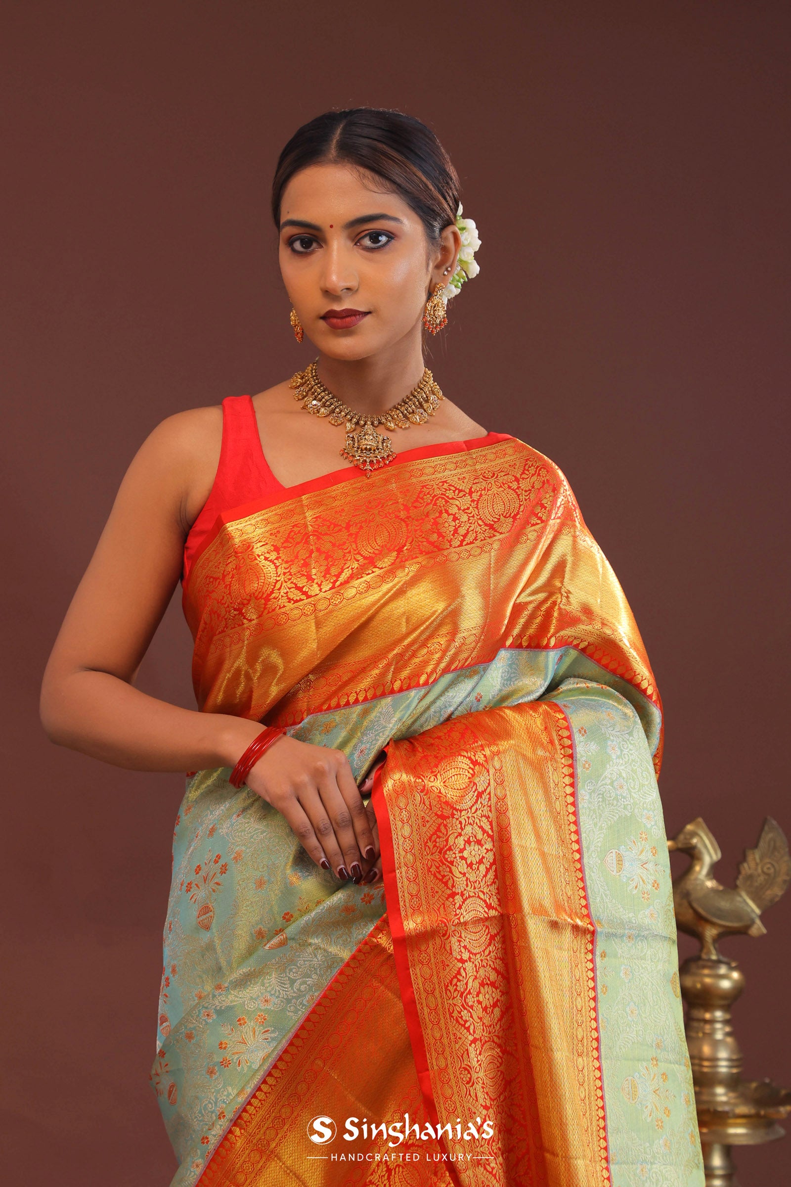 Pistachio Green Kanjivaram Tissue Saree With Contrast Orange Border