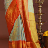 Pistachio Green Kanjivaram Tissue Saree With Contrast Orange Border