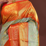 Pistachio Green Kanjivaram Tissue Saree With Contrast Orange Border