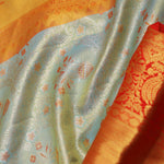 Pistachio Green Kanjivaram Tissue Saree With Contrast Orange Border