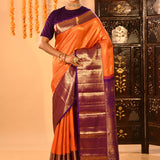 Vibrant Orange With Zari Checks And Purple Border On Kanchipuram Silk Saree