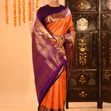 Vibrant Orange With Zari Checks And Purple Border On Kanchipuram Silk Saree