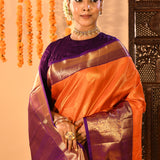 Vibrant Orange With Zari Checks And Purple Border On Kanchipuram Silk Saree