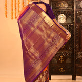 Vibrant Orange With Zari Checks And Purple Border On Kanchipuram Silk Saree