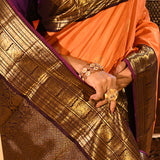 Apricot Orange Kanjivaram Silk Saree With Purple Contrast Zari Border