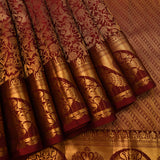 Deep Maroon Kanjivaram Silk Saree With Gold Zari Shikargah Floral Jaal And Grand Peacock Arch Border Weave
