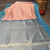 Kanjivaram Silk Saree In Peach With Silver Zari Floral Jaal And Contrast Teal Paisley Border