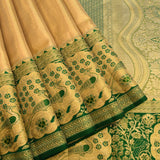 Graceful Metallic Beige And Green Kanjivaram Silk Saree With Gold Zari Peacock Motifs