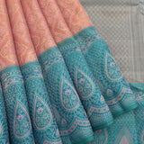 Kanjivaram Silk Saree In Peach With Silver Zari Floral Jaal And Contrast Teal Paisley Border