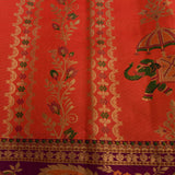 Kanjivaram Silk Saree In Orange Red With Elephant Shikargah And Contrast Purple Multicolour Paisley Border