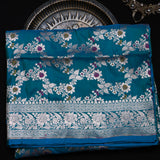 Peacock Blue Banarasi Silk Saree With Silver Zari Floral Vine And Scroll Border
