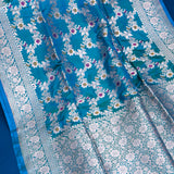 Peacock Blue Banarasi Silk Saree With Silver Zari Floral Vine And Scroll Border