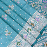 Teal Banarasi Silk Saree With Silver Zari Butti Body And Contrast Paisley Border