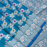 Peacock Blue Banarasi Silk Saree With Silver Zari Floral Vine And Scroll Border