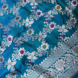 Peacock Blue Banarasi Silk Saree With Silver Zari Floral Vine And Scroll Border