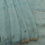 Dusty Blue Organza Saree With Hand Embroidered Floral Booti And Antique Gold Leaf Border