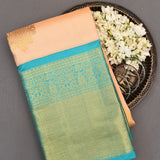 Peach And Teal Kanjivaram Silk Saree With Gold Zari Buttis And Diamond Trellis Border