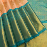 Peach And Teal Kanjivaram Silk Saree With Gold Zari Buttis And Diamond Trellis Border