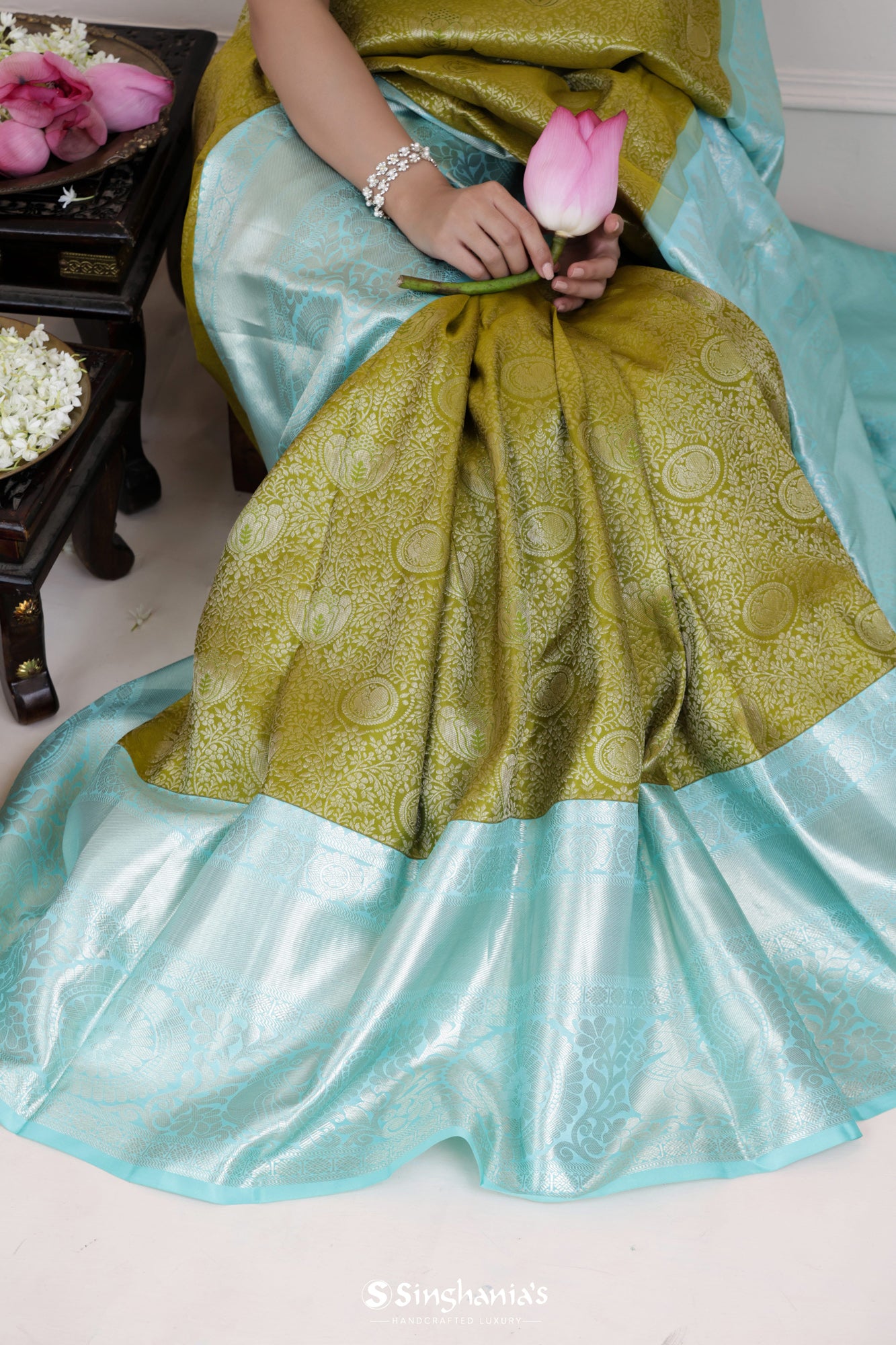 Olive Green Kanjivaram Silk Saree With Mayil Chakra And Floral Weaving